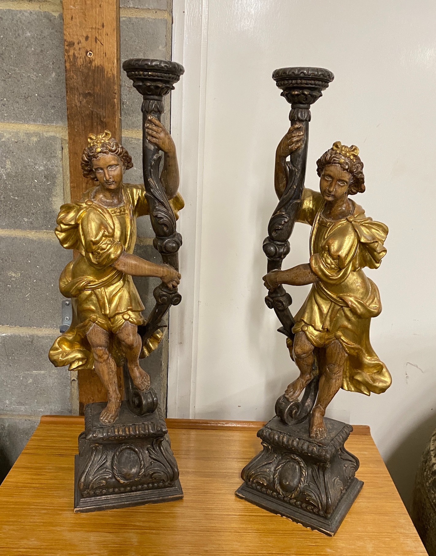 A pair of 18th century style carved pine parcel gilt figural lamp bases, height 75cm